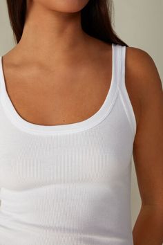 Racerback vest top in Supima® cotton. Designed to be worn as underwear or outerwear. Soft and comfortable. White Ribbed Scoop Neck Tank Top, Classic Seamless Everyday Tank Top, Classic Everyday Seamless Tank Top, White Ribbed Sleeveless Tank Top, White Sleeveless Ribbed Tank Top, Basic Bra-friendly Scoop Neck Tops, Basic Scoop Neck Bra Friendly Tops, Basic Bra Friendly Scoop Neck Tops, Basic Scoop Neck Tops, Bra Friendly