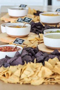 chips, salsa and dips are arranged on a table for a party or gathering