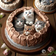 three cats are sitting in the middle of a cake on top of a wooden table