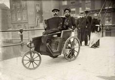 an old photo of people riding in a carriage