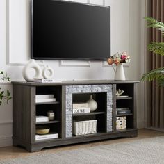 a flat screen tv mounted to the side of a wooden entertainment center in a living room