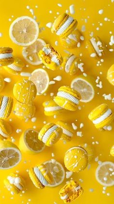 lemons and marshmallows are arranged on a yellow surface with white speckles