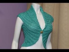 a mannequin wearing a green knitted shawl