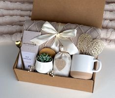 a gift box with coffee mugs and other items