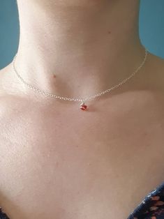 This is a beautiful dainty carnelian gemstone and sterling silver choker necklace.  DETAILS: - A single 4mm carnelian bead is in a wire wrapped spiral suspended from recycled sterling silver chain.  - There are also carnelian beads on the hand finished clasp for a special touch (a Dainty Rose detail). - Carnelian is a fiery red and is know to be a powerful stone of courage and energy. It is a very popular gemstone so this would be ideal as a gift. Or as a treat for yourself!  - It is perfect for layering. This necklace is also available in other gemstones in my shop.  Please note all of my jewellery is handmade and so may differ slightly to the piece photographed but that means that each piece will be unique!  The necklace photographed measures at about 15 inches. POSTAGE AND PACKAGING: Al Minimalist Red Gemstone Birthstone Necklace, Minimalist Red Birthstone Necklace, Red Minimalist Birthstone Necklace, Sterling Silver Necklace Dainty, Tiny Pendant Necklace, Sterling Silver Choker Necklace, Spiral Pendant, Dainty Rose, Tiny Pendant