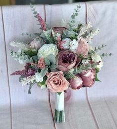 a bouquet of flowers sitting on top of a white chair