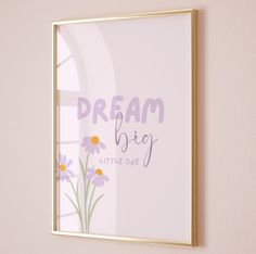 a frame hanging on the wall above a window with flowers and words written in it