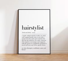 a black and white poster with the words hairstylist on it in an empty room