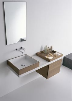 a bathroom with a sink, mirror and soap dispenser