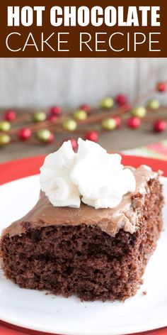 a piece of chocolate cake on a plate with whipped cream and chocolate frosting in the middle