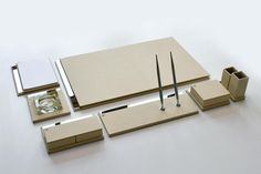 an assortment of office supplies on a white surface with scissors and other items around it