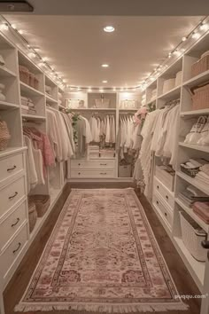 a walk in closet filled with lots of white furniture and drawers next to a rug