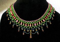 the necklace is adorned with multicolored beads and glass bead details on a black mannequin