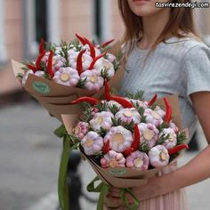 the woman is holding three bouquets of flowers