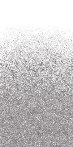 a black and white photo of the back side of a cell phone with silver glitter on it