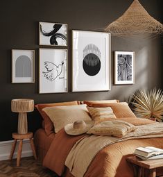 a bedroom with brown walls and pictures on the wall above the bed in front of it