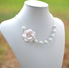 "Featuring Hand Sculpted White Rose Necklace , matching Pearls earrings included. Variety White Flower Jewelry available in my shop MATERIAL AND SIZE: Rose Flower size is approximately 1.1/2\" across. 10mm white Glass Pearls. Swarovski Pearls Available with additional cost. Silver Plated Chain (pictured). Antiqued Brass and gold plated available. The entire necklace is approximately 18 inches with 2\" extender, finished with lobster clasp. I would be happy to resize the length per request. Packe White Flower Necklace, Rose Flower Jewelry For Bridesmaid Gift, Rose-colored Flower Pendant Jewelry For Weddings, Rose Flower Necklaces For Wedding, Flower Shaped Rose Design Necklaces For Wedding, Rose Flower Necklace For Wedding, Elegant Rose Jewelry With Handmade Flowers, Flower Pendant Jewelry With Rose Design For Wedding, White Rose Design Necklace For Wedding