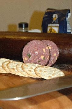 some food is laying out on the counter next to a cutting board and knifes