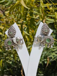 These are german silver earrings and are authentic INDIAN TRIBAL DESIGN. Elephants in Indian culture define tranquility and prosperity that is why they are worn by Indian tribal women. The eye of the earring is made by jade stone. There is intricate carving done on the earrings to enhance its features. Handmade Traditional Jade Earrings, Traditional Handmade Jade Earrings, Elegant Ceremonial Earrings With Oxidized Finish, Elegant Oxidized Earrings For Ceremonial Occasion, Bohemian Jade Gemstone Earrings, Handmade Spiritual Jade Earrings, Traditional Jade Jewelry For Weddings, Elegant Jewelry With Matching Earrings For Rituals, Elegant Silver Carved Earrings