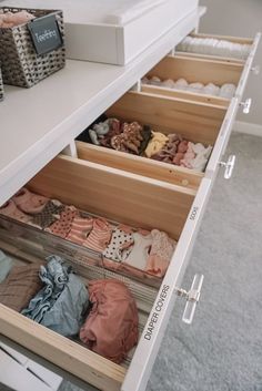 an open drawer with clothes in it