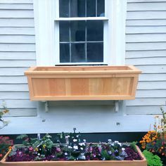 a window sill filled with flowers next to a house