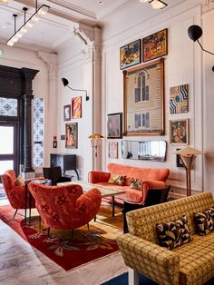 a living room filled with furniture and pictures on the wall