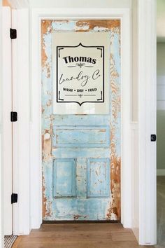 an old blue door with a sign on it that says, the laundry room is open