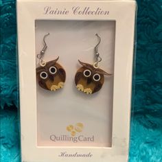 the earrings are made out of wood and have an owl's head on it