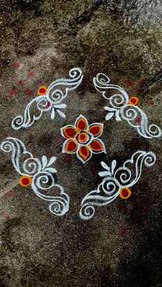 an artistic design on the ground with red and white flowers painted on it's side