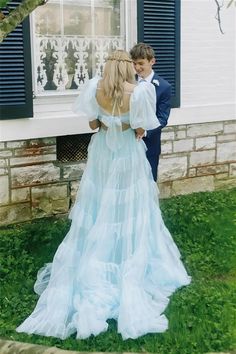 two people standing in front of a house