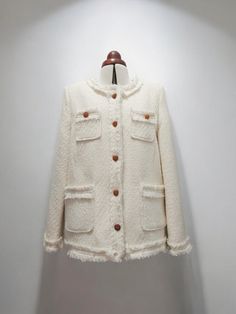 Stay cozy and chic this season with our exquisite Handmade Tweed Boucle Down Jacket. Crafted from high-quality cream and white tweed, this luxurious outerwear piece is designed to keep you warm while making a fashion statement. The unique boucle texture adds depth and sophistication, making it a standout addition to any outfit. Featuring elegant metal buttons that provide a touch of modern flair, this jacket effortlessly combines classic style with contemporary details. The plush down filling en White Winter Tweed Jacket With Buttons, Winter Double-breasted Tweed Jacket With Hidden Buttons, Classic Cream Single-breasted Tweed Jacket, White Tweed Jacket With Button Closure, White Single-breasted Tweed Outerwear, White Tweed, Metal Buttons, Winter Looks, Down Jacket