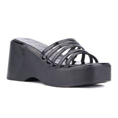 The Dreamer wedge sandal offers a perfect blend of style and comfort, featuring a strappy upper that infuses the design with understated dimensional detailing. Its convenient slide silhouette ensures easy wear, making it a versatile choice for both workdays and weekend outings. The wedge heel provides just the right amount of lift while maintaining all day comfort, allowing you to transition seamlessly from the office to brunch with friends. Elevate your footwear collection with the Dreamer for Black Synthetic Wedge Heel Sandals, Black Synthetic Wedge Sandals With Heel Loop, Spring Black Platform Slippers With Heel Loop, Black Platform Slippers With Heel Loop For Spring, Modern Black Platform Slippers With Wedge Heel, Strappy Synthetic Wedge Sandals With Heel Loop, Modern Black Synthetic Wedge Sandals, Modern Black Wedge Heel Sandals, Black Strappy Synthetic Wedge Sandals