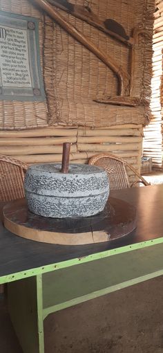 a large stone bowl sitting on top of a wooden table