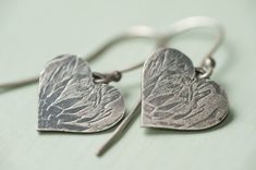 The protea is South Africas national flower.  These beautiful heart earrings have a protea imprint on them.  They are handmade in sterling silver and have been oxydised to give the imprint a black colour. The width of the heart is approximately 1.5cm wide. The hooks are sterling silver. Metal Stamped Jewelry, Types Of Earrings, Engraved Jewelry, Stamped Jewelry, Shell Necklaces, Wood Jewellery, Heart Jewelry, Heart Earrings, Jewelry Ideas