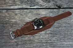 Leather cuff watch band for men. Brown wrist watch strap in Aviator style is unique, no two straps are the same. Compatible with watch case 18 mm, 20 mm, 22 mm, 24mm. Bund band is soft, does not stretch, comfortable, durable and fits perfectly on the wrist, enhances the beauty of your watch. Made of best Turkish leather. Will appeal to connoisseurs of vintage style. Handmade leather bund band is a good and thoughtful gift for your dear person, which will remind you of you for a long time. Leather Watch Band, Cuff Watch, Aviator Style, Leather Watch Strap, Leather Watch Bands, Leather Cuffs, Cuff Bangles, Watch Case, Wrist Strap