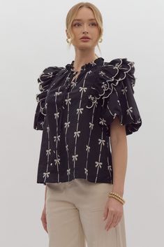 True to size, I am an 8/10 wearing a medium. 100% cotton bow print short puff sleeve v-neck top featuring tiered scallop ruffles at shoulders. Self-tie detail at ruffled neckline. Unlined, woven, non-sheer, lightweight. Small 4-6Medium 8-10Large 12-14 Cotton Summer Tops With Bow Print, Cotton Tops With Bow Print And Short Sleeves, Summer Short Sleeve Tops With Bow Print, Cotton Puff Sleeve Top With Bow, White Bow Print Short Sleeve Top, Bow Blouse, White Bow, V Neck Tops, Printed Shorts