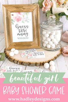 an adorable floral baby shower game with white flowers in a wooden frame on a table