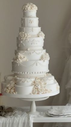 a white wedding cake sitting on top of a table