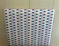 a blue and white bag sitting on top of a wooden table next to a wall