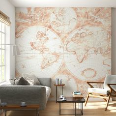 a living room filled with furniture and a large map on the wall above it's coffee table