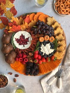 a platter filled with fruit and nuts