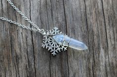 "Let your inner Elsa shine with this beautiful snowflake and ice shard necklace! Child size suggestions at very bottom. The glass crystal is opalite, and it shines an array of colors in the light--it has a rainbow effect. The crystal is roughly 1.25 inches long. The snowflake is about 1 inch in diameter and features one rhinestone in the center, and 6 around the edges. Together, the pendant hangs about 1.75 inches long. Various chain length options available. The necklace features a lobster claw Ice Accessories, Frozen Necklace, Ice Jewelry, Ice Necklace, Costumes 2024, Frozen Snowflake, Elsa Costume, Dragon Heart, Crystal Ice