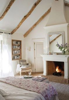 a bedroom with a fireplace and white walls