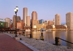 the city skyline is reflected in the water