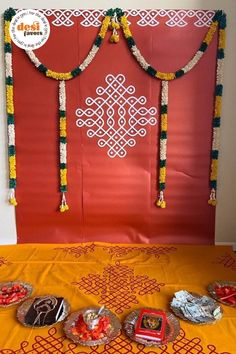 an orange and yellow table cloth with some decorations on it