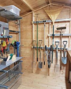 an organized garage with lots of tools hanging on the wall and shelves filled with gardening implements