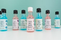 six bottles of hand sanitizers are lined up on a white surface, each containing different flavors