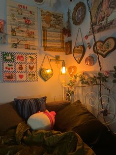 a bed with lots of pillows and pictures on the wall