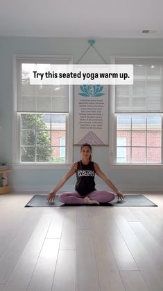 a woman sitting in a yoga position with the words try this seated yoga warm up