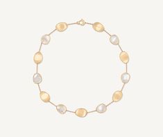 Elegant and minimalist, this necklace comprises a regular sequence of light 18K yellow gold leaves and mother of pearl. The gold leaves are hand-engraved using the ancient Florentine technique, alternated with a slender chain. Perfect to complete any look and add a finishing touch of light. Elegant Engraved Mother Of Pearl Jewelry, Elegant Engraved Mother Of Pearl Necklace, Elegant Hammered Oval Necklace, Elegant Oval Hammered Necklace, Gold Mother Of Pearl Necklace With Polished Finish, Elegant White Hammered Jewelry, Luxury Yellow Gold Hammered Necklace, Elegant Yellow Gold Mother Of Pearl Necklace, Yellow Gold Mother Of Pearl Necklace For Wedding